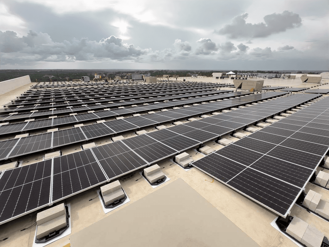 Aerial view of a large commercial rooftop solar array by NATiVE Solar.